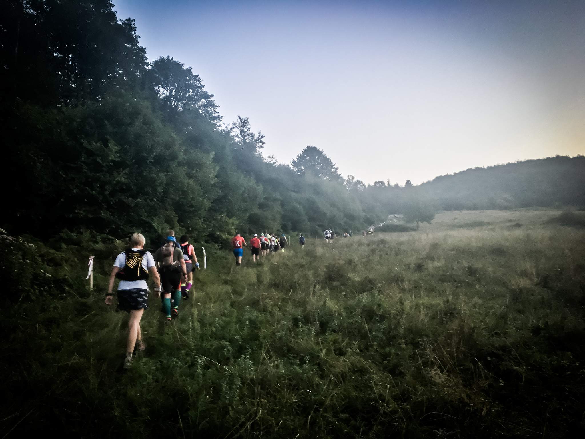 A line of runners on the first climb in early morning of the race